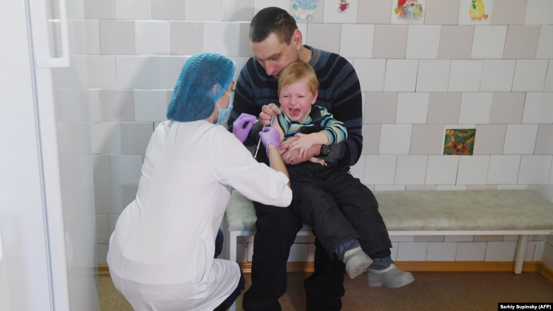 A child receives a vaccination in Ukraine, the country worst hit by Europe's measles epidemic.