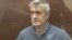 RUSSIA -- Founder of the Baring Vostok private equity group Michael Calvey, who was detained on suspicion of fraud, sits inside a defendants' cage as he attends a court hearing in Moscow, February 15, 2019