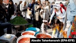 Iranians go shopping at a street market for the New Persian Year, called Norouz, in Tehran, March 19, 2018