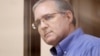 Paul Whelan looks out of the defendants' cage before a court hearing in Moscow on January 22.