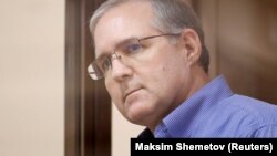 Paul Whelan looks out of the defendants' cage before a court hearing in Moscow on January 22.