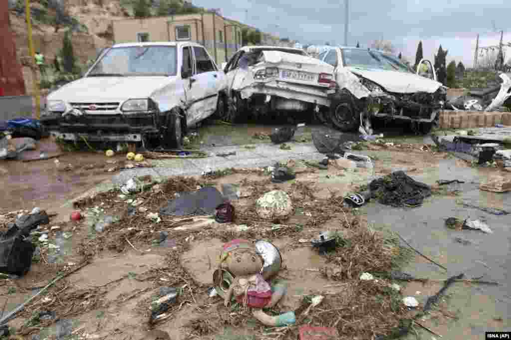 A child&#39;s toy and destroyed cars in Shiraz.