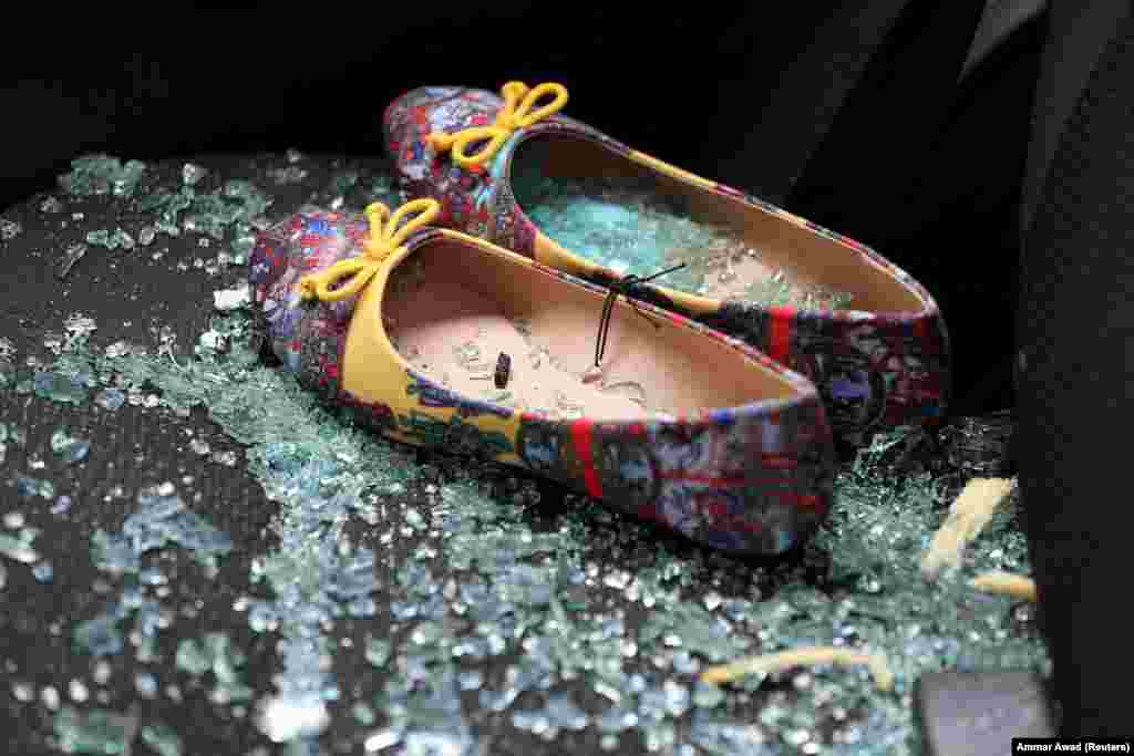 Shattered glass covers shoes left on the seat of a car that was damaged after a rocket hit a house north of Tel Aviv, Israel, on March 25. (Reuters/Ammar Awad)