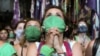 A demonstrator in favour of legalizing abortion reacts as the senate debates an abortion bill, in Buenos Aires, Argentina, December 30, 2020.
