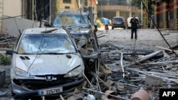 People inspect the damage caused by an Israeli strike that targeted the Sfeir neighborhood in Beirut’s southern suburbs on October 6. 