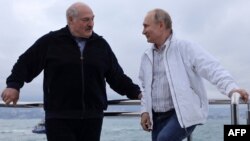 Pushing ahead with crackdowns: Russian President Vladimir Putin (right) and Belarusian leader Alyaksandr Lukashenka on the Black Sea on May 29.