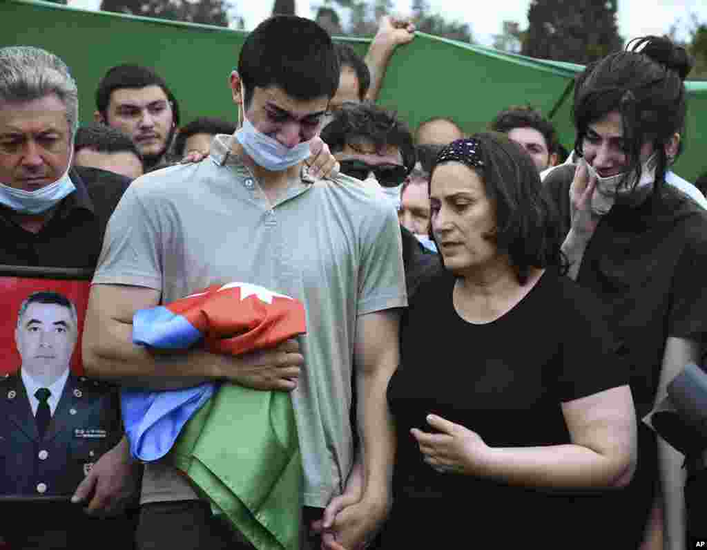 Сын и вдова азербайджанского полковника Ильгара Мирзаева на его похоронах в Баку. Мирзаев был среди пяти азербайджанских военнослужащих, которые 14 июля погибли в боях на границе Азербайджана и Армении