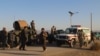 Afghan security force arrive near the site after a suicide bomber blew himself up inside a packed mosque on aa base in Khost on November 23.