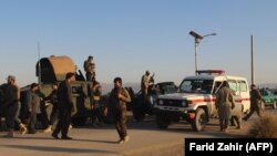 Afghan security force arrive near the site after a suicide bomber blew himself up inside a packed mosque on aa base in Khost on November 23.