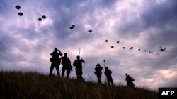 NATO paratroopers drop out of a U.S. Air Force Hercules during a military exercise in Bulgaria in July.