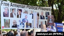 Armenia - Protesters hold pictures of jailed opposition figures during EU Commission President Ursula von der Leyen's talks with Prime Minister Nikol Pashinian, Yerevan, July 2, 2026.