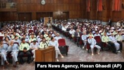 This photo released by the semi-official Iranian Fars News Agency, shows a general view of the court room where dozens of opposition activists and peaceful protesters are standing trial, in Tehran's Revolutionary Court, Iran, Aug. 25, 2009.