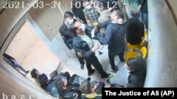 In another frame grab from the hacked video, a guard beats a prisoner at Evin prison.