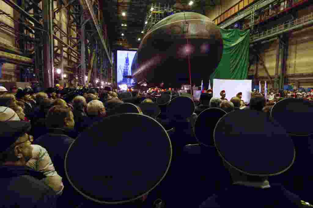 Russian sailors and workers attend a ceremony to launch the diesel-electric submarine &quot;Novorossiysk&quot; at the Admiralteiiskiye Shipyard in St. Petersburg. 