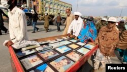 Relatives display pictures of people who have gone missing in restive province of Balochistan.