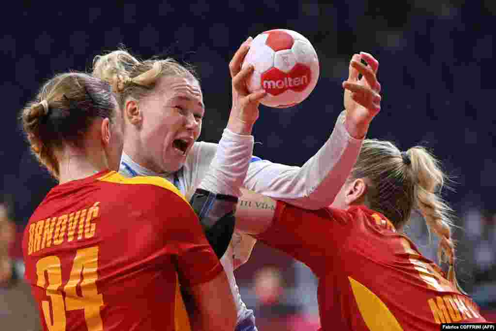 Russia's pivot Kseniia Makeeva (Center) is challenged during the women's quarterfinal handball match between Montenegro and Russia of the Tokyo 2020 Olympic Games at the Yoyogi National Stadium in Tokyo on August 4, 2021.