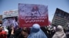 Afghan women hold up placards of Farkhunda Malikzada during a protest in Kabul in July 2015.