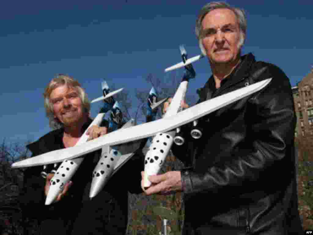 U.S. -- Space Tourism 23Jan2008 - Sir Richard Branson (L), founder of Virgin Galactic, and Burt Rutan (R), CEO of Scaled Composites, unveiled the design of the Spaceship Two (C, under wing) and White Knight Two carrier aircraft 23 January 2008 at the America Museum of Natural History in New York. Virgin Galactic will attempt to launch paying customers into sub-orbital space flights with the Spaceship Two.