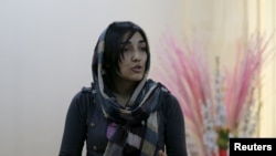 An Afghan woman speaks during a class of the gender and women's studies masters program at Kabul University on October 19.