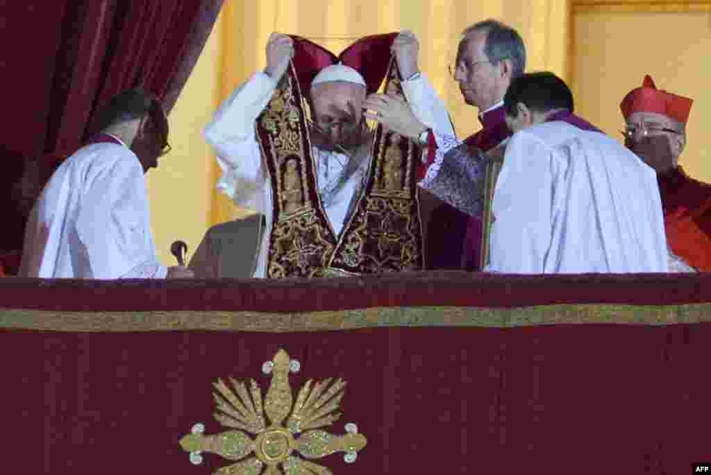 Newly elected Pope Francis appears at the window of St Peter's Basilica's balcony.