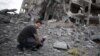 Gaza -- A photo made available by the Associated Press news agency of video journalist Simone Camilli filming destroyed buildings in Beit Lahiya, Gaza Strip 11 August 2014. 