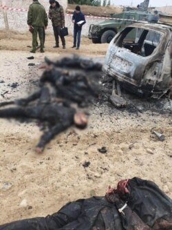 The second photo showing the handcuffed man. In the background are three badly burned bodies of alleged attackers (blurred by RFE/RL).