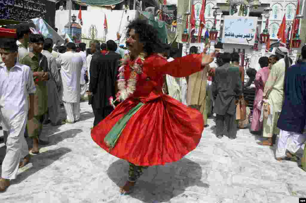 A Sufi devotee dances during annual celebrations at the shrine. Every year, the site is host to the world&#39;s largest Sufi festival.&nbsp;