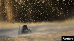 A U.S. Army Explosive Ordnance Disposal robot is seen during an explosion of an improvised explosive device in Arghandab valley, northwest of Kandahar, in Afghanistan.