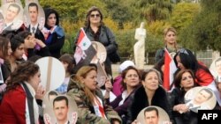 An official handout photo showing Syrian supporters of President Bashar al-Assad protesting in Damascus on November 14.