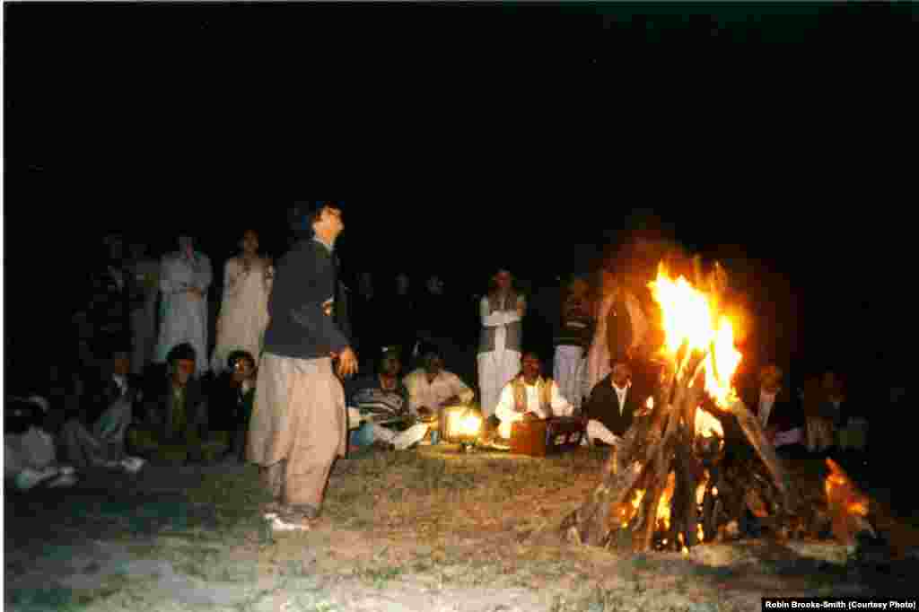 Student enjoying a bonfire during a retreat.
