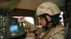 Iraq -- U.S. army soldier from 256th Brigade Combat Team (BCT), 2nd Battalion preparing his humvee's Blue Force Tracker before departing Camp Victory, 12Jun2006
