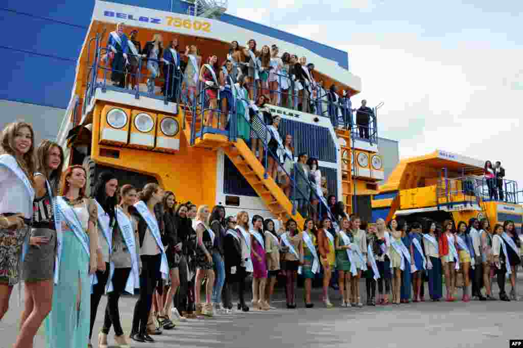 Contestants in the Miss Supranational 2013 beauty contest pose for a photo atop a huge mining truck during a visit to the BelAZ plant in the Belarusian city of Zhodino. Minsk is hosting Miss Supranational 2013, an annual international beauty contest run by the World Beauty Association based in Panama. (AFP/Viktor Drachev)