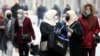 Women wearing face masks walk on the street in Sarajevo last month. By December 11, there were 99,543 confirmed infections and 3,250 COVID-19 deaths in the country of 3.4 million..