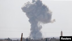 Smoke rises after a U.S.-led air strike on the Syrian town of Kobani, which has been under siege by Islamic State militants for a number of days.