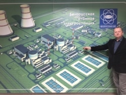 Eduard Svirid points to a site map of the nuclear power plant at the project's information center in Astravets.