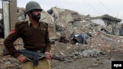 A Pakistani soldier at the site of a market destroyed in fighting between pro-Taliban militants and security forces in North Waziristan.