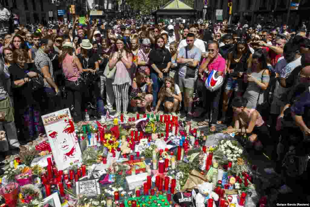 People pay tribute to the victims of the Barcelona terror attack outside the Liceu Theatre on Las Ramblas. A van rammed into a crowd along a section of Las Ramblas, the city&#39;s most famous boulevard, killing 13 people and injuring dozens more. (epa/Quique Garcia)