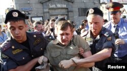 Police detain an opposition activist taking part in the "Day of Wrath" protest rally in central Moscow on June 28.