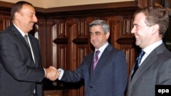 Russian President Dmitry Medvedev (right) looks on as his counterparts Serzh Sarkisian (center) and Ilham Aliyev shake hands at talks over Nagorno-Karabakh in 2008. Can Russia bring an end to such conflicts in the former Soviet space?