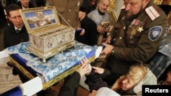 Russia -- Orthodox Christians surround a chest containing the Cincture of the Virgin Mary, held by priests and Cossacks, at the Pokrovsky cathedral in the Siberian city of Krasnoyarsk, 03Nov2011