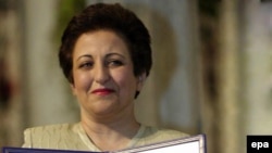 Shirin Ebadi holds her Nobel diploma as she receives the 2003 Nobel Peace Prize in Oslo