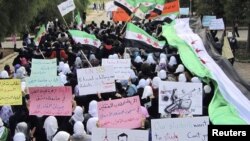 Anti-regime demonstrators march in the town of Homs on November 21.