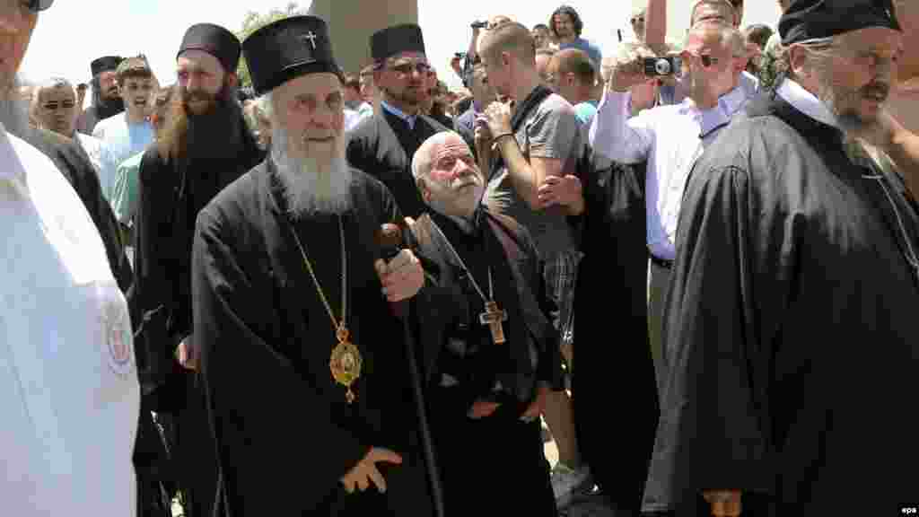 Serbian Orthodox Patriarch Irinej (second left) arrives to celebrate St. Vitus Day in Gazimestan.