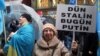 A woman holds a sign reading, "Yesterday Stalin, Today Putin" at a protest in Istanbul against Russian actions in Crimea.