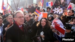 Armenia - Ambassador Henri Reynaud (L) is greeted by young Armenians demonstrating outside the French Embassy in Yerevan, 24Jan2012.