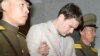 Otto Frederick Warmbier (C), a University of Virginia student who was detained in North Korea since early January, is taken out of North Korea's top court after being sentenced, in Pyongyang, March 16, 2016