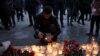A man lights a candle during a memorial service for victims of a blast in the subway in St. Petersburg on April 3.