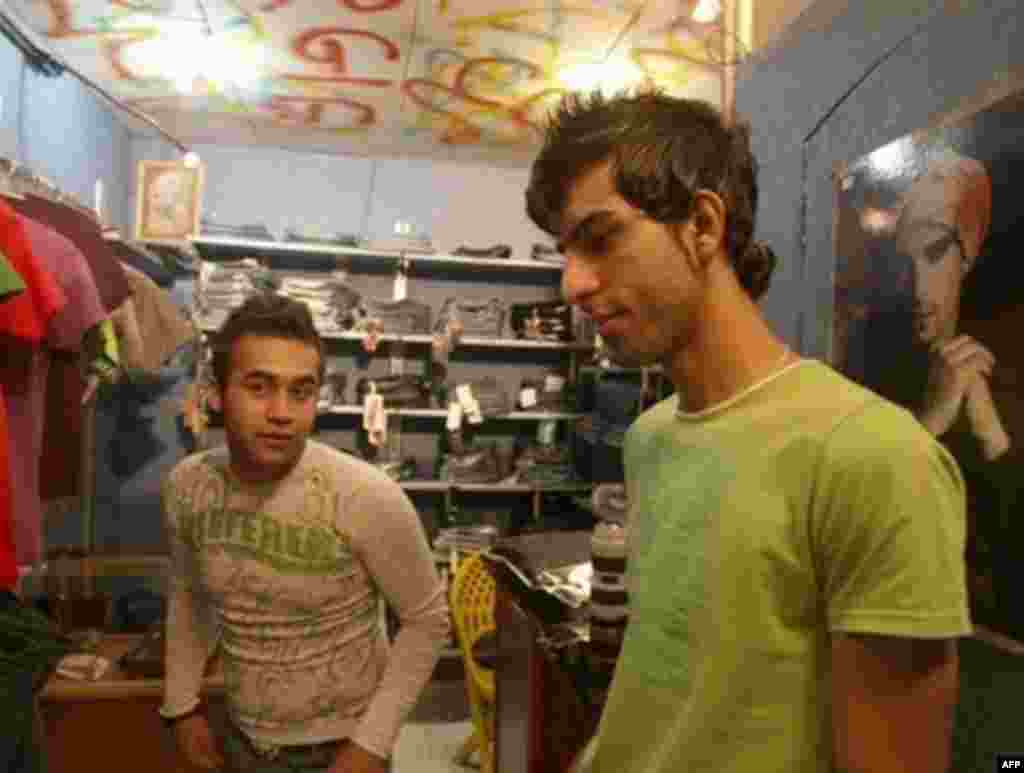 Iran's dress code prohibits men from wearing short-sleeve shirts or Western-style haircuts, but many fashion-conscious young Iranians, like these Tehran shopkeepers, choose to ignore the strict rules.