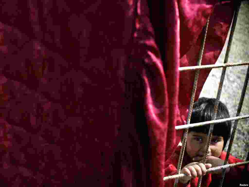 A Romany child plays in his quarter in the northern Kosovo town of Mitrovica on April 7. In Kosovo, despite efforts made by the government and international organizations, Roma still face unemployment and poverty and live in the margins of society. Photo by Hazir Reka for Reuters