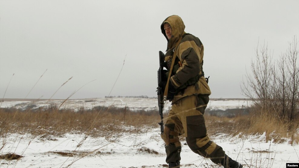 A separatist soldier walks in a field near the line of contact where a cease-fire is scheduled to take effect at midnight on December 24.